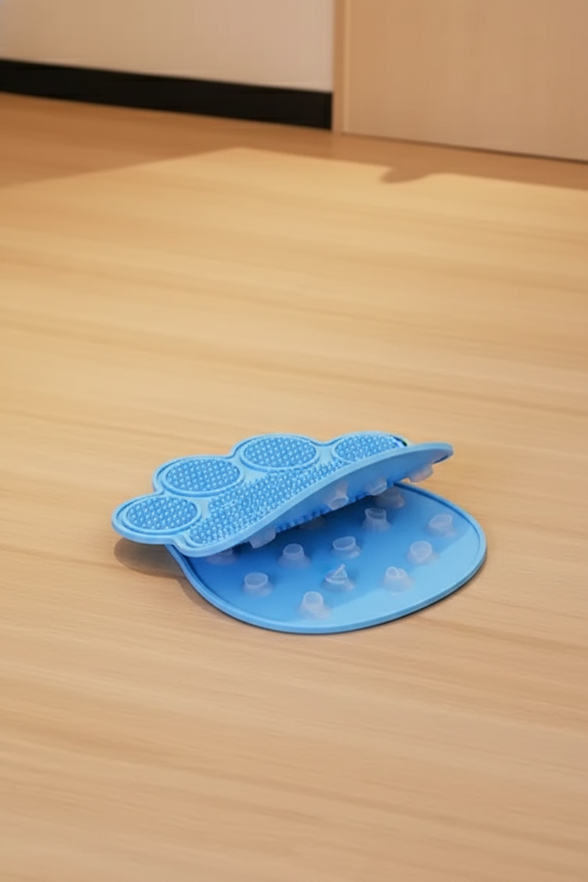 Macro of blue silicone paw-shaped lick mat texture and suction cup underside — kept. v2